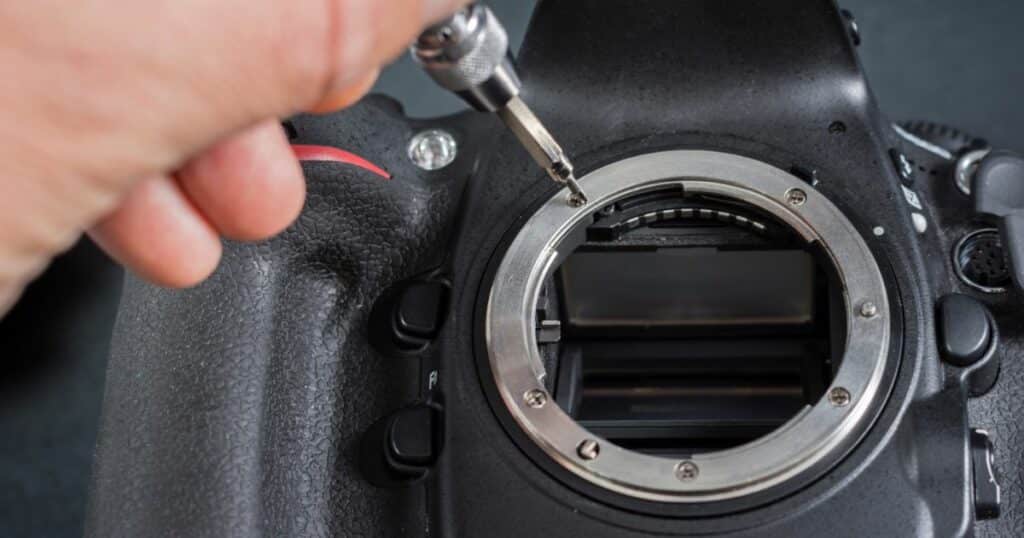 man repairing camera lens