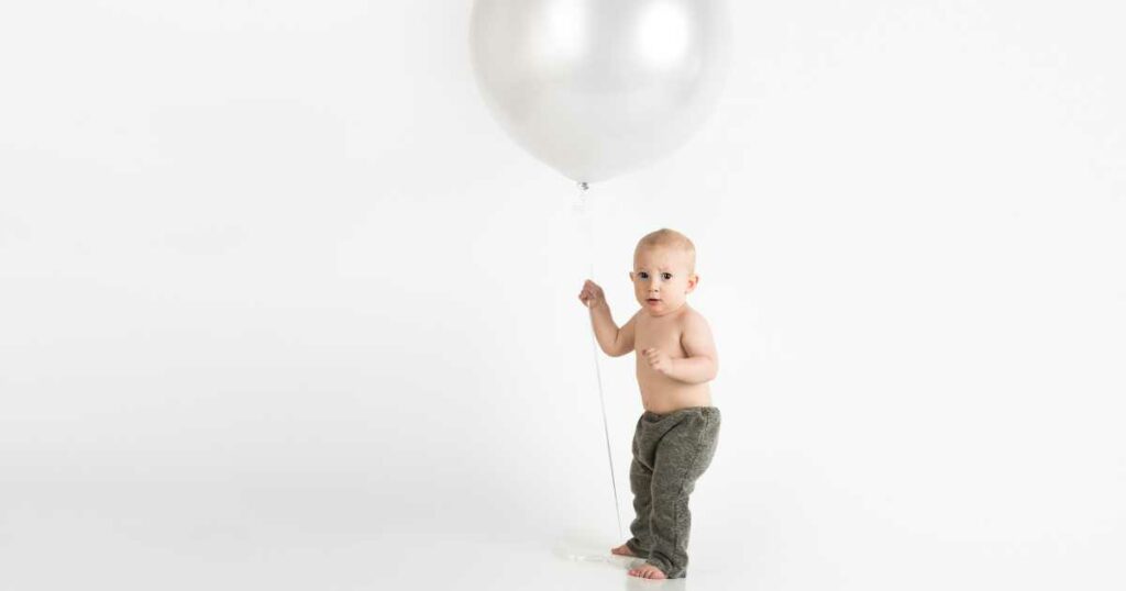baby holding a balloon