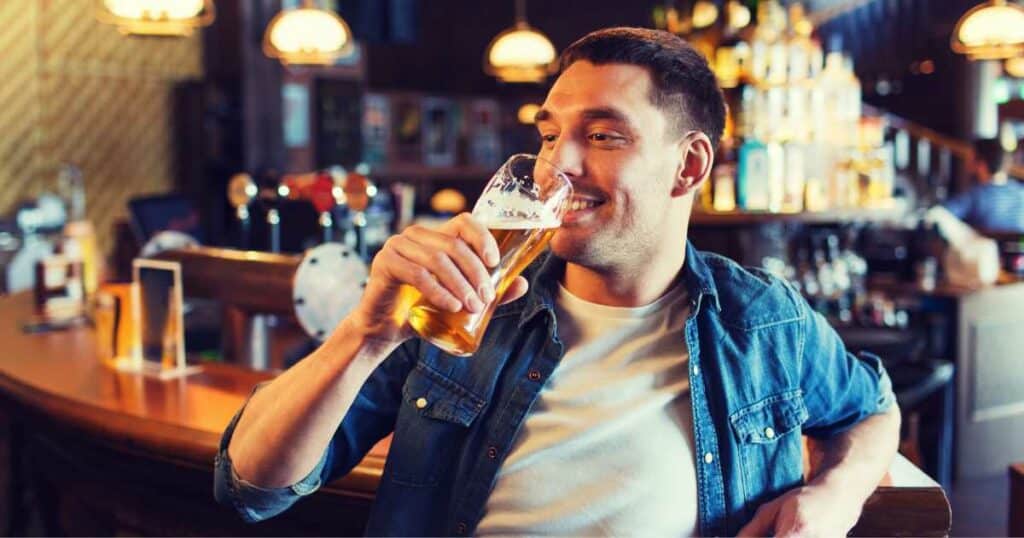 man drinking in bar